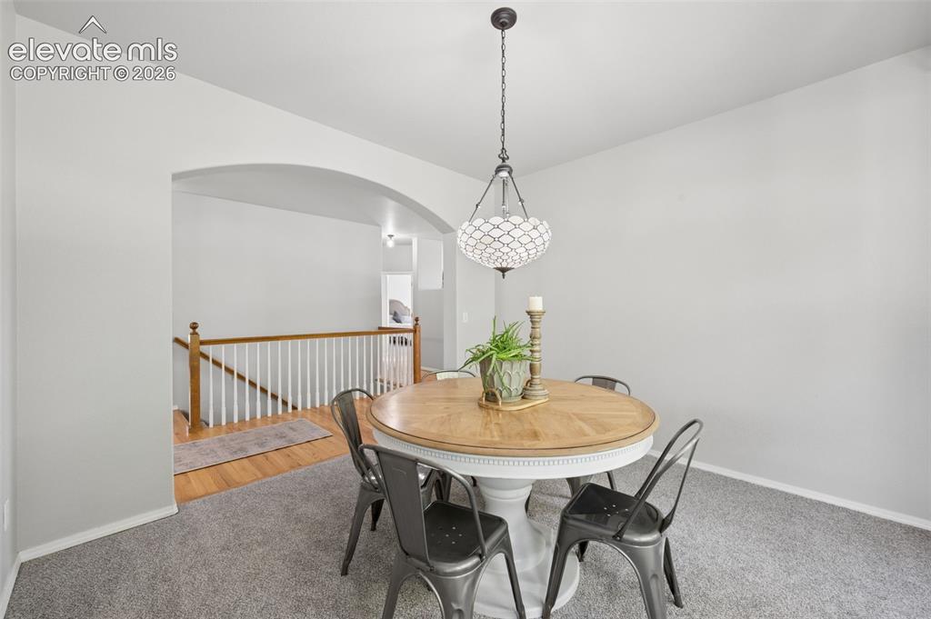 Image 9 of 37: Neutral-toned room featuring a decorative lantern-style pendant light, an a