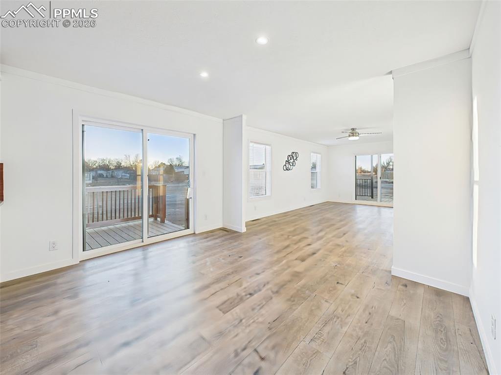 Image 11 of 50: This bright, open-concept kitchen and dining space features crisp white cab