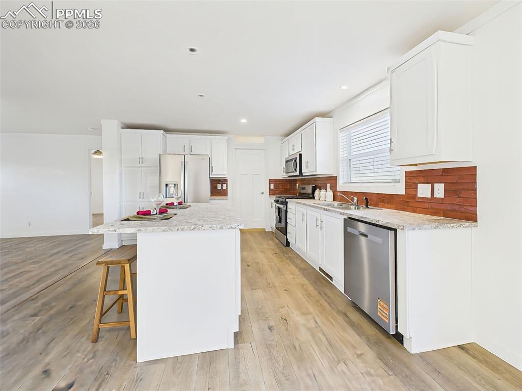 Image 15 of 50: Stretching along the side wall, this kitchen offers generous counter space,