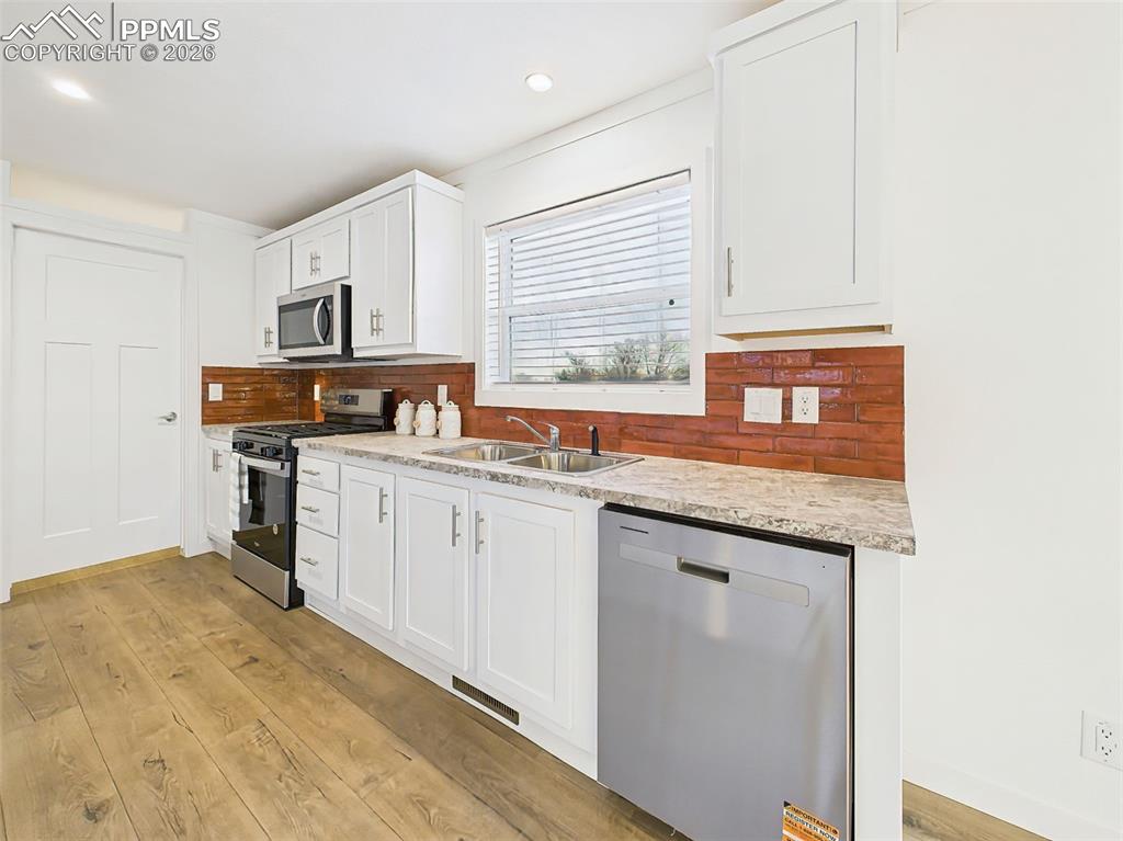 Image 16 of 50: This spacious kitchen highlights the functionality of extended countertop s