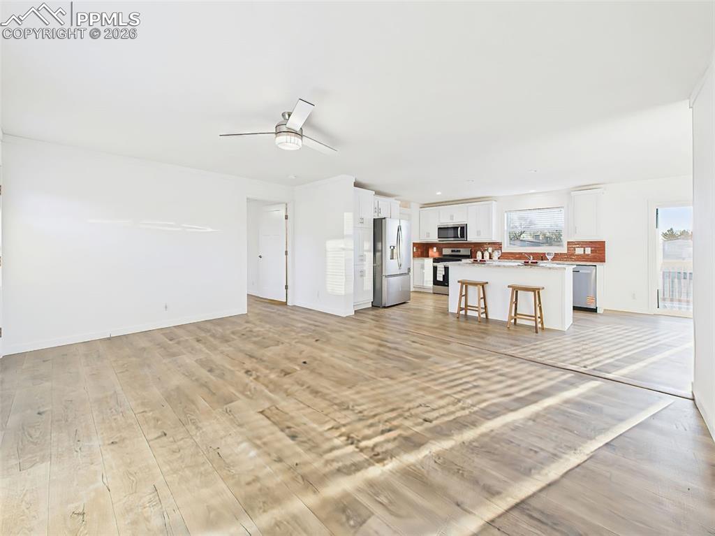 Image 21 of 50: Wide plank floors and abundant sunlight define this spacious layout, where
