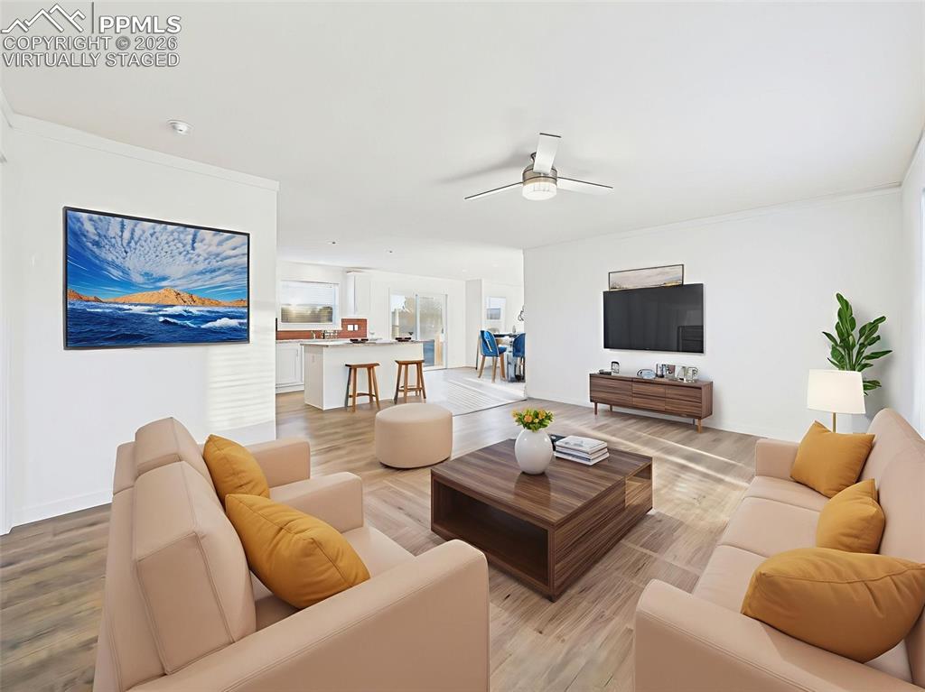 Image 24 of 50: Virtually Staged This versatile great room connects effortlessly to the kit