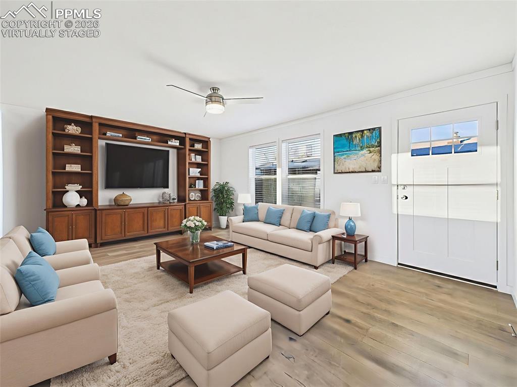 Image 26 of 50: Virtually Staged A welcoming front living room complete with large windows,