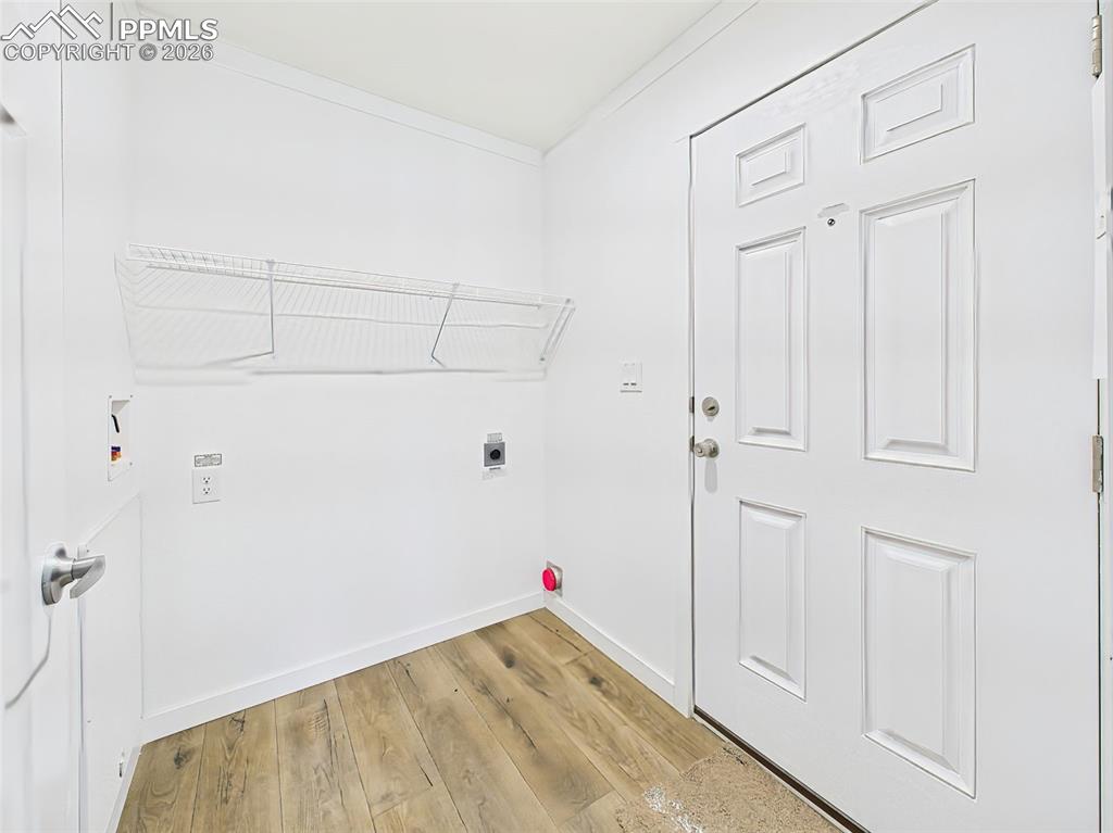 Image 37 of 50: Convenient side entry with washer/dryer hookups, storage shelving, and easy