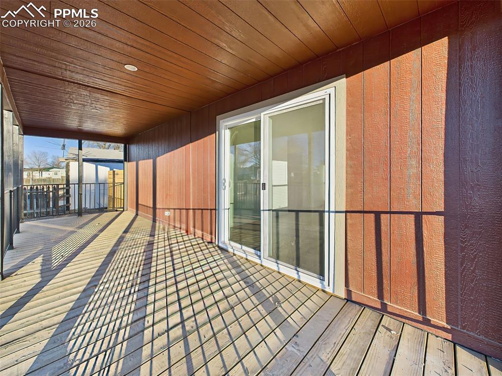 Image 39 of 50: The covered deck provides a shaded, private space ideal for relaxing or ent