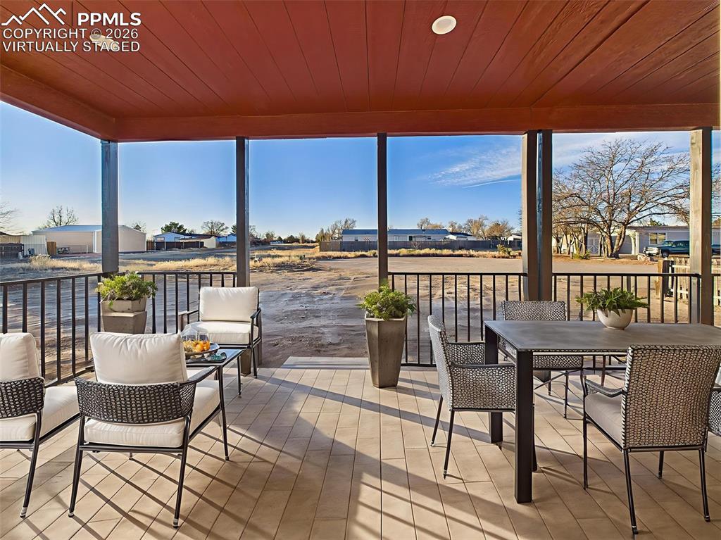 Image 42 of 50: Virtually Staged Enjoy outdoor living year-round on this spacious covered p