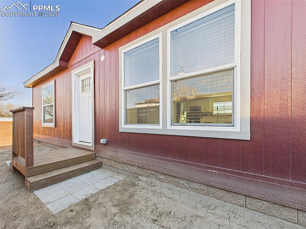 Image 48 of 50: Front door porch located in fenced area