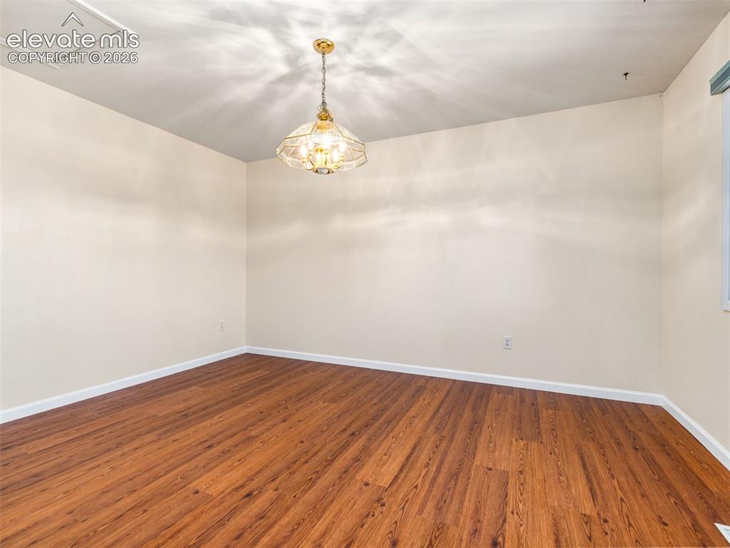 Image 14 of 24: Neutral wall finishes complementing wood-finish flooring