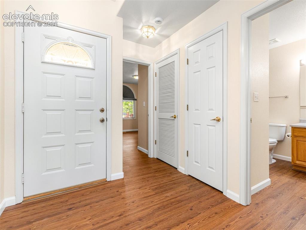 Image 5 of 24: Entryway featuring wood-finish flooring, a six-panel door with an arched gl