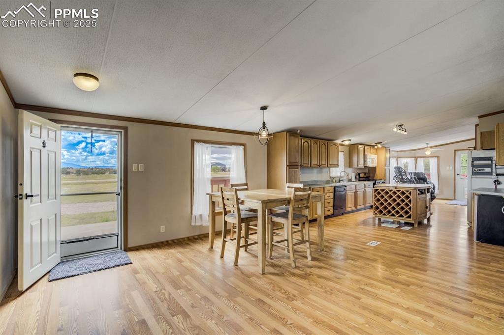 Image 12 of 43: Dining space featuring light wood-style floors and ornamental molding