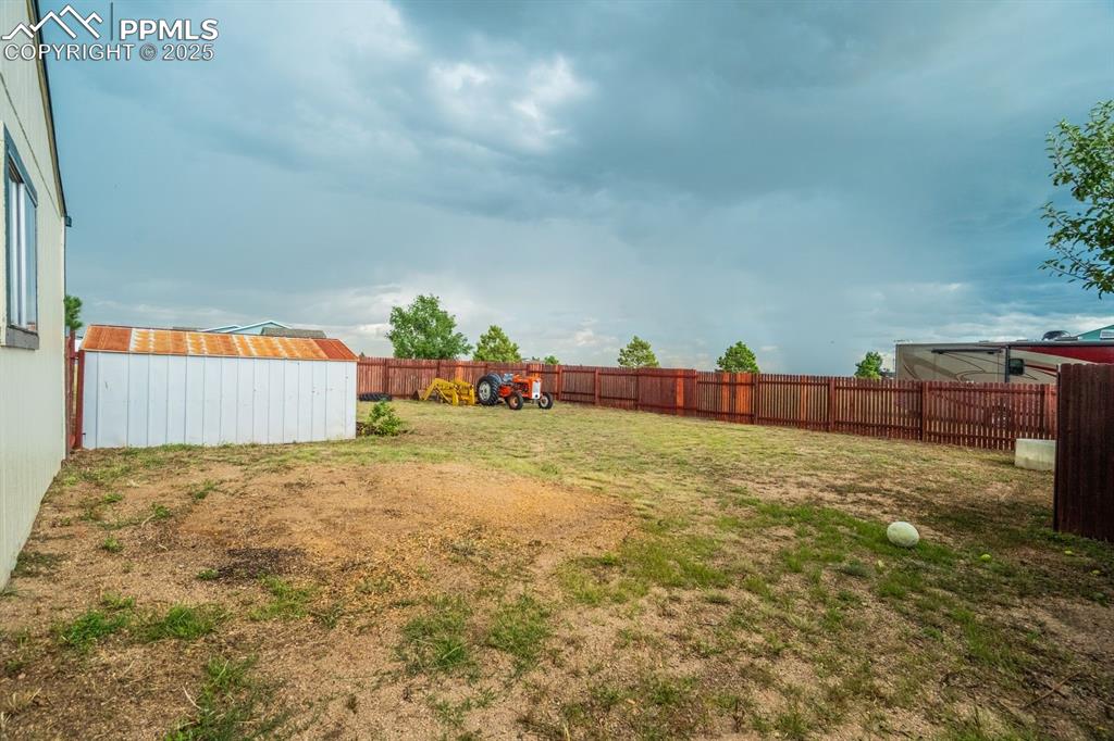 Image 36 of 43: View of fenced backyard