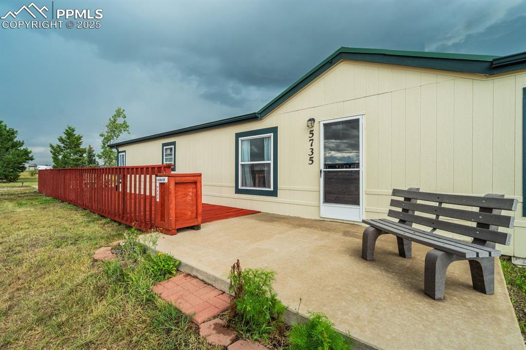Image 8 of 43: Rear view of house with a yard