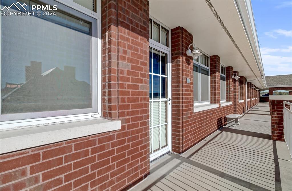 Image 35 of 42: Covered walkway off primary bedroom -put some potted flowers out there or a