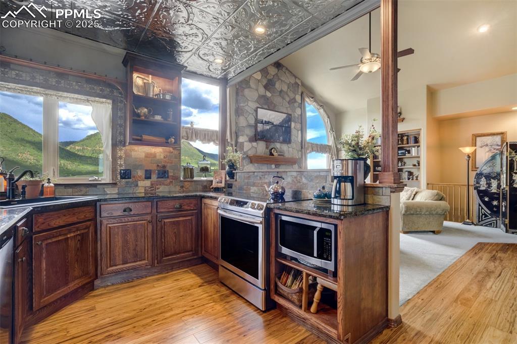 Image 11 of 50: Beautifully updated kitchen with granite counters, stainless appliances, ti