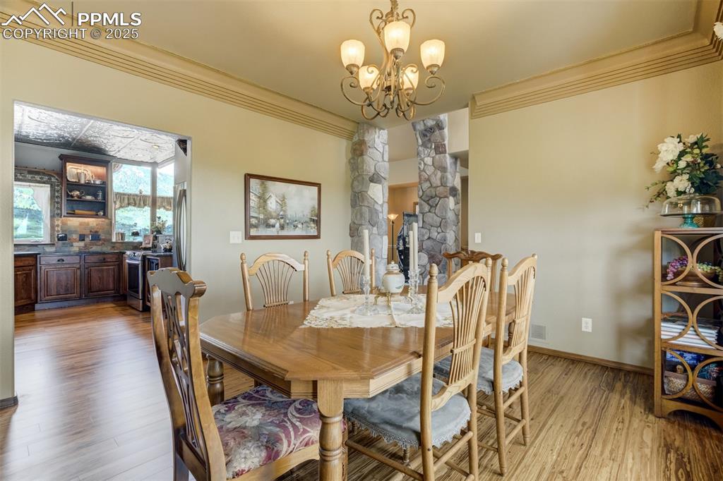 Image 16 of 50: Formal dining with bay window, city views, and eucalyptus flooring