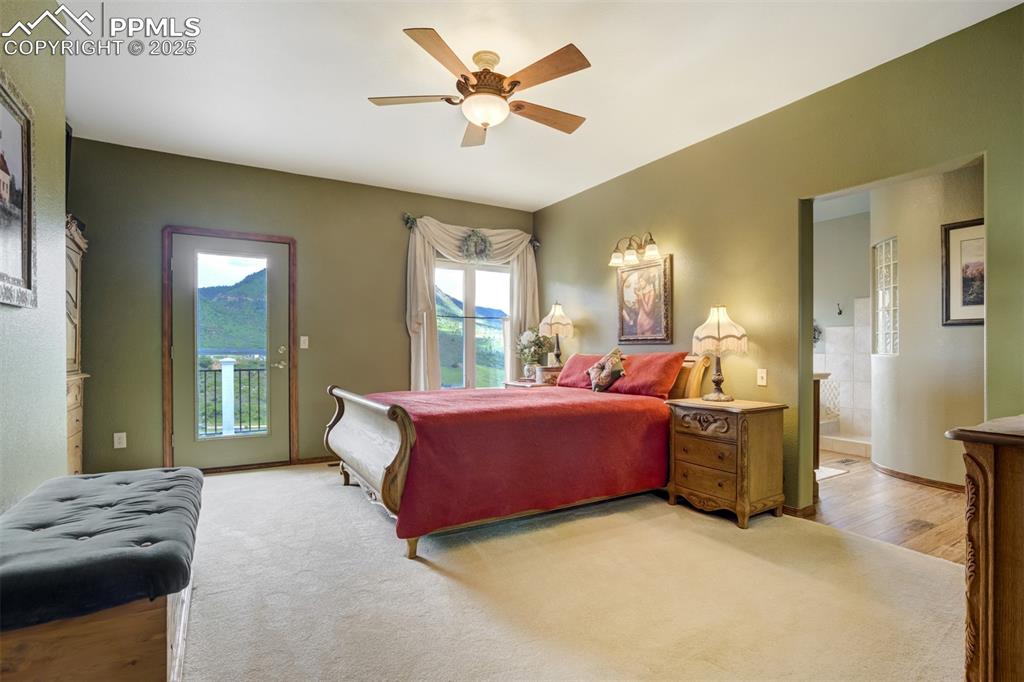 Image 22 of 50: Master suite with 5 pc bath, walk-out to deck, and walk-in closet