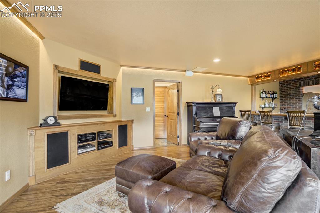 Image 31 of 50: Basement family room offers gas fireplace
