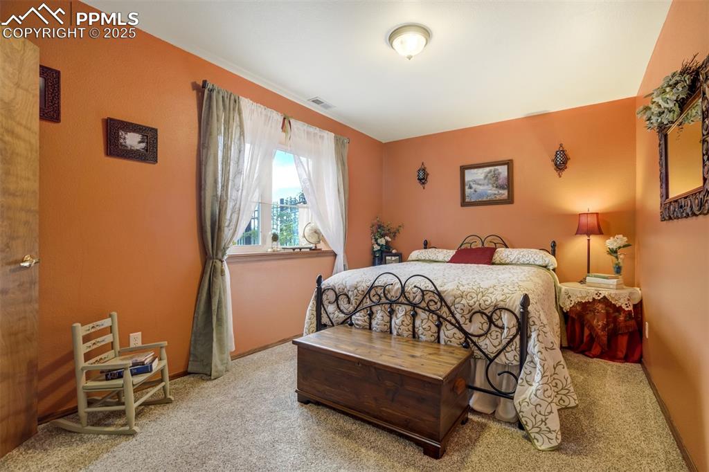 Image 36 of 50: Basement bedroom #4 is garden level with foothill views and includes a larg