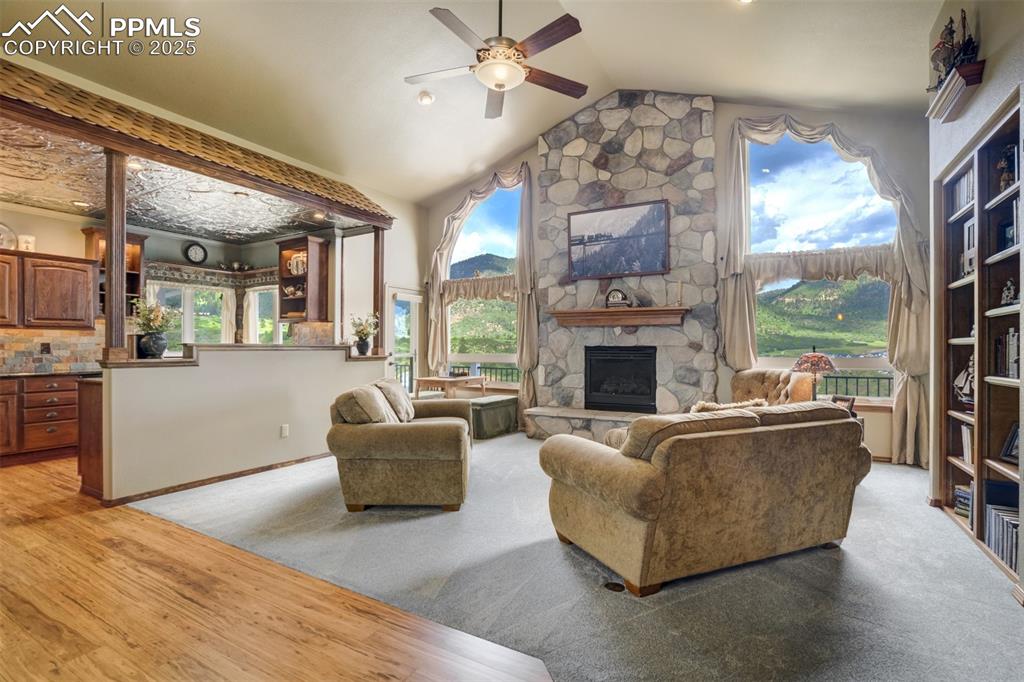 Image 7 of 50: Great room with stone fireplace and huge foothill views