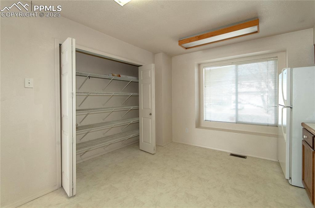 Image 10 of 25: Kitchen features a large pantry