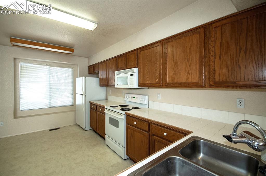 Image 11 of 25: Kitchen as viewed from the counter bar