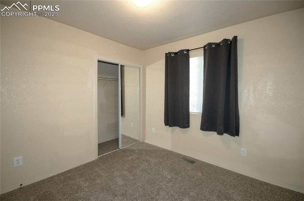 Image 14 of 25: Second bedroom featuring fresh paint and new carpet