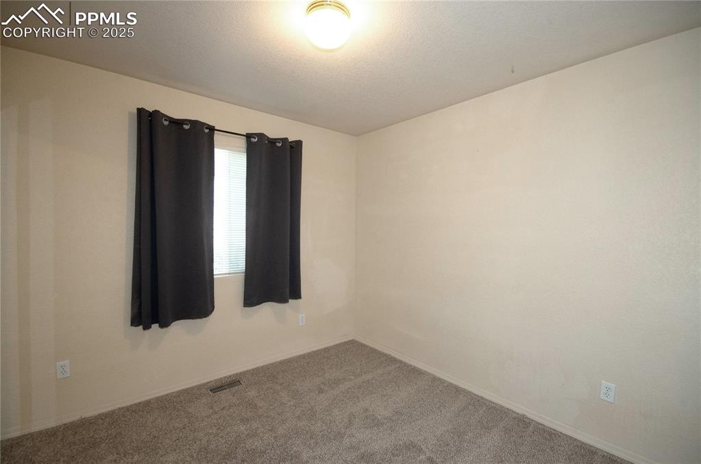 Image 15 of 25: Second bedroom featuring fresh paint and new carpet