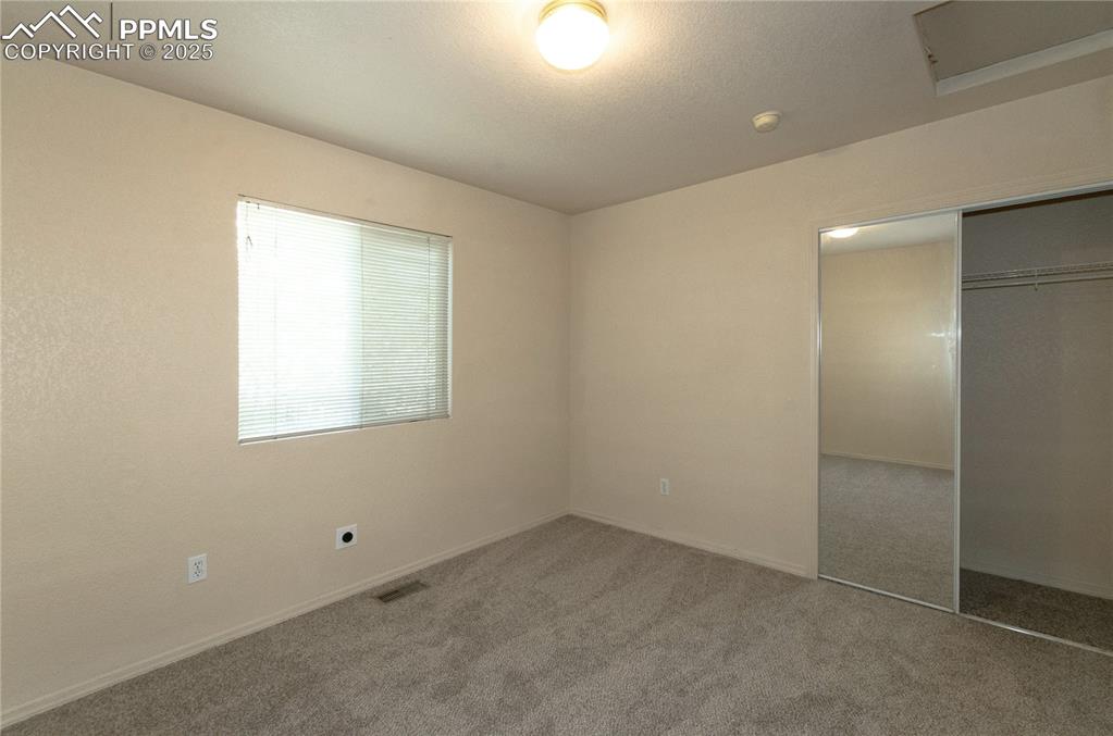 Image 16 of 25: Third bedroom featuring fresh paint and new carpet