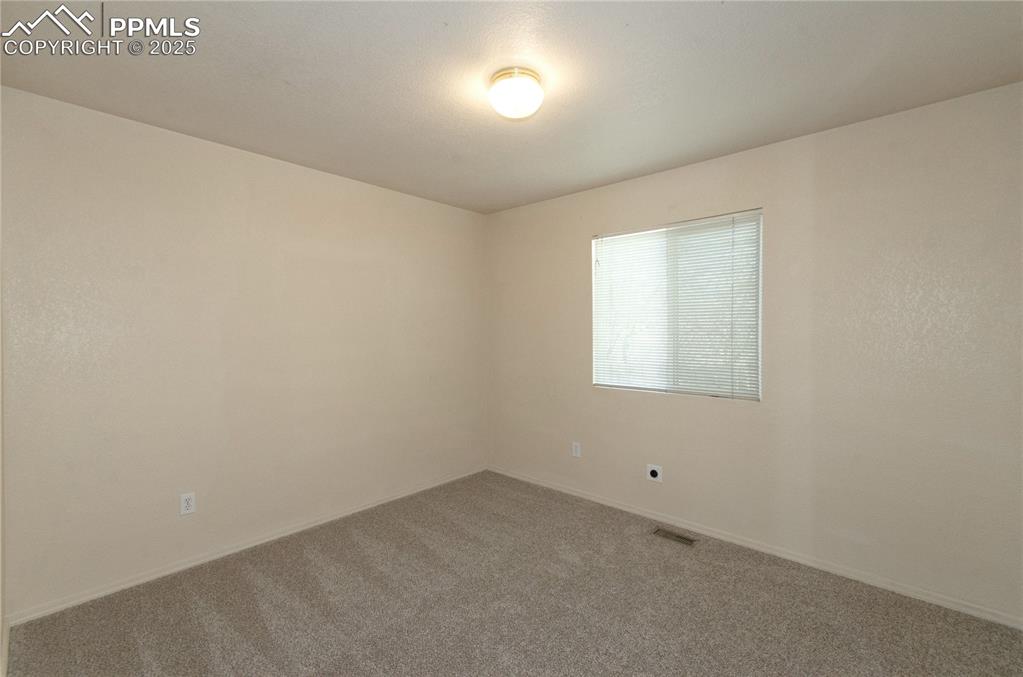 Image 17 of 25: Third bedroom featuring fresh paint and new carpet