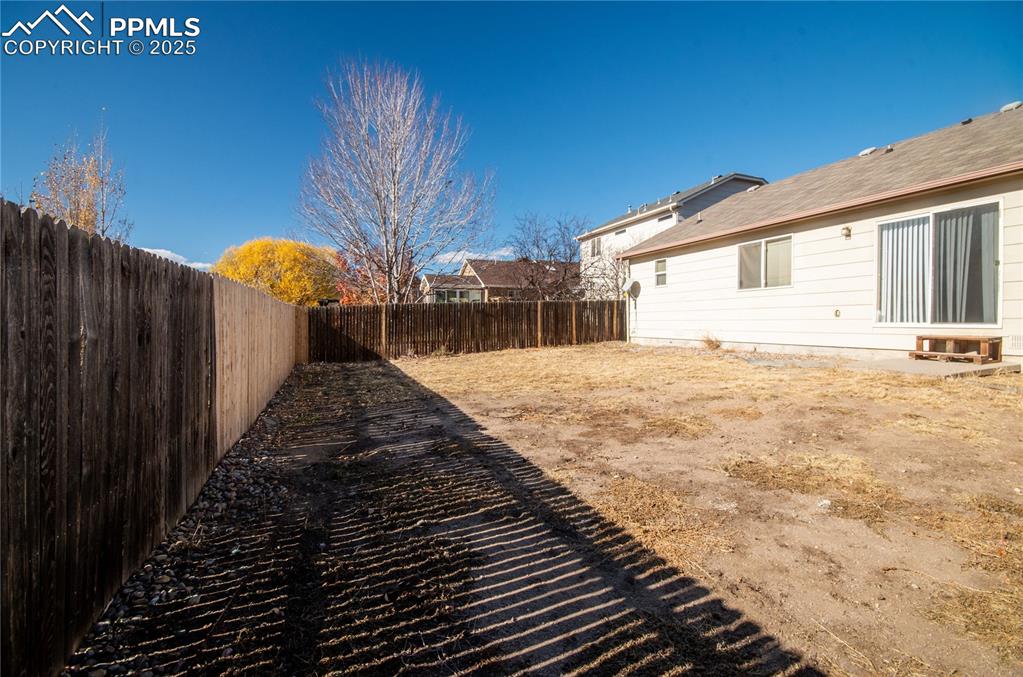 Image 23 of 25: View of fenced backyard