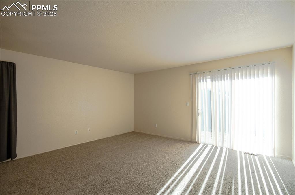 Image 4 of 25: Living room with walk-out to the backyard