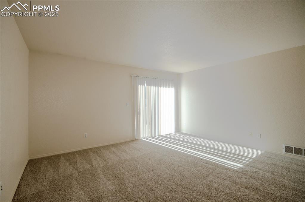 Image 8 of 25: Living room and walk-out to the backyard