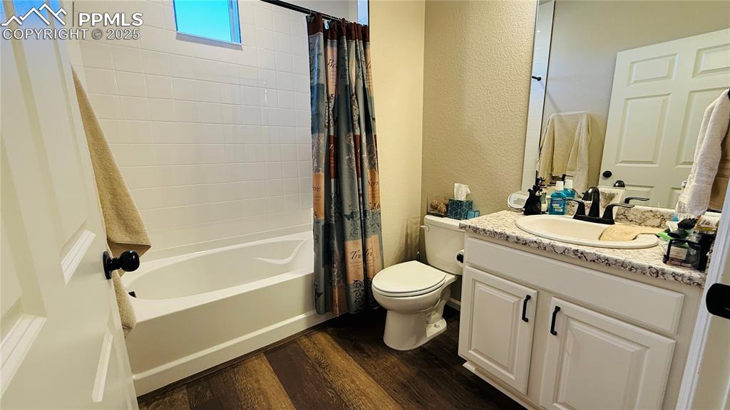 Image 17 of 28: Full 2nd bathroom with dark wood-type flooring on main level