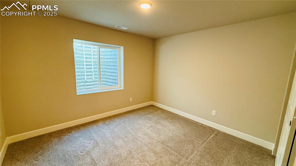 Image 20 of 28: Basement bedroom with carpet flooring