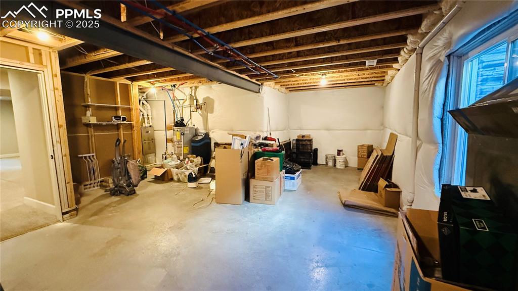 Image 24 of 28: Unfinished below grade area with water heater