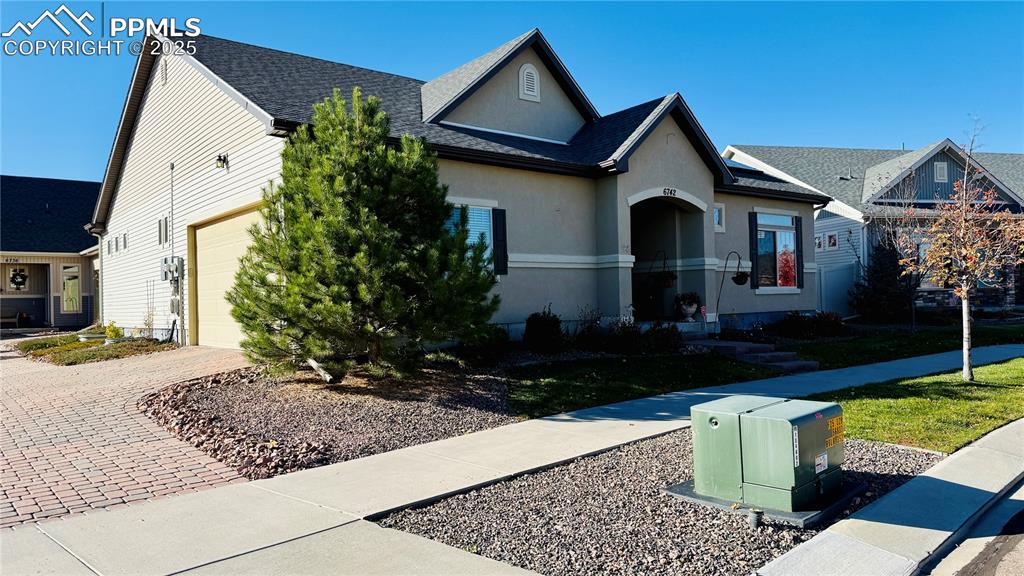 Image 3 of 28: View of front of home featuring stucco siding, roof with shingles, and deco