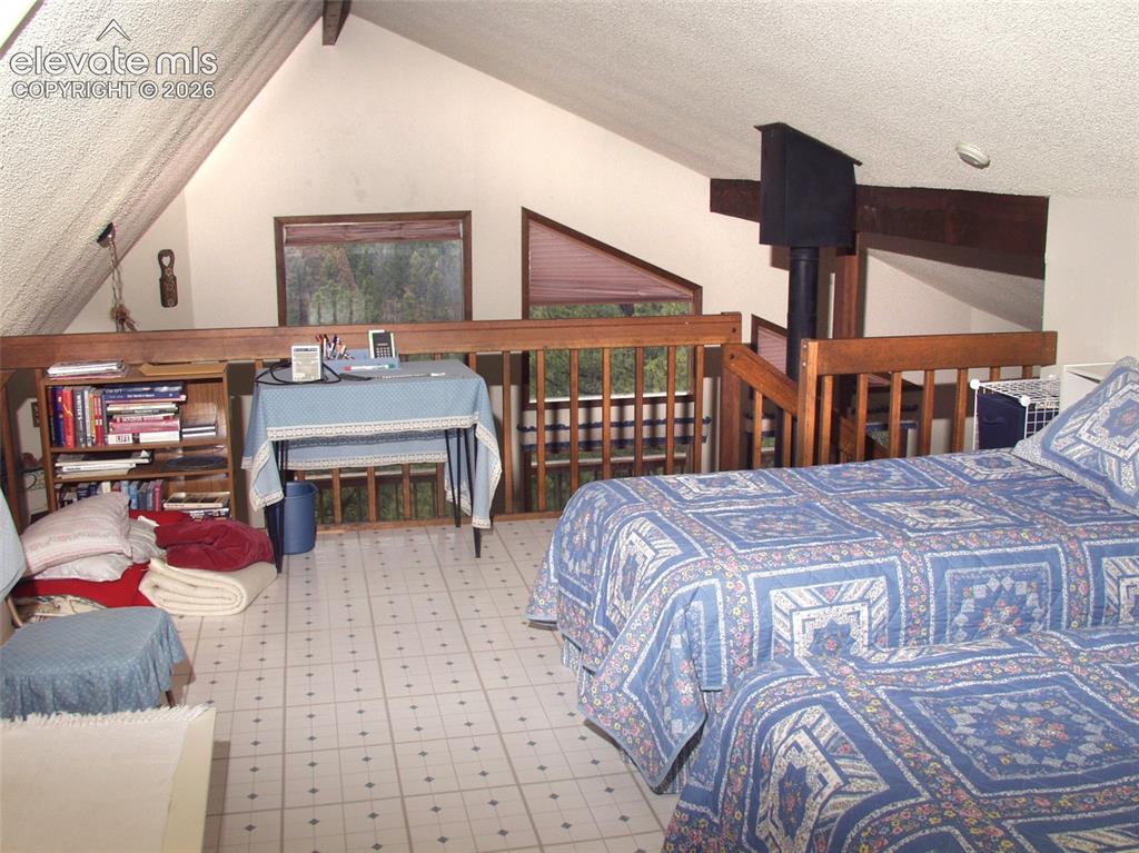 Image 23 of 33: additional sleeping area w/ walk-out to balcony.