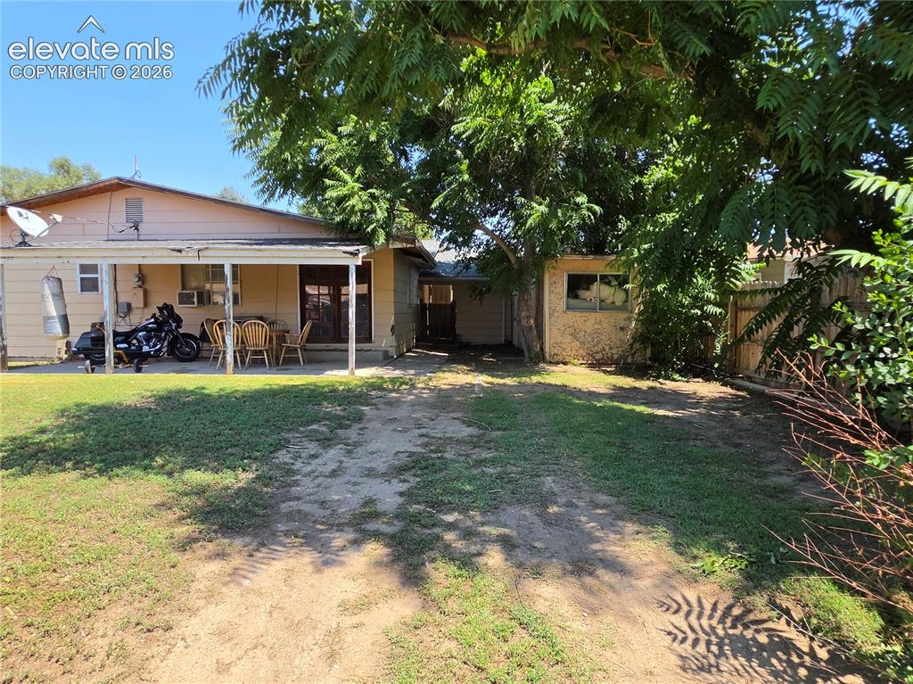 Image 5 of 39: Patio & 2 storage sheds