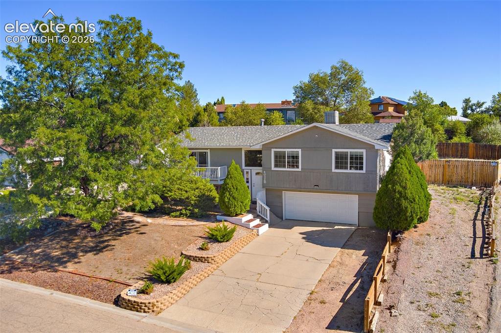 Image 1 of 24: View of front facade featuring a 2 car garage and additional parking with a