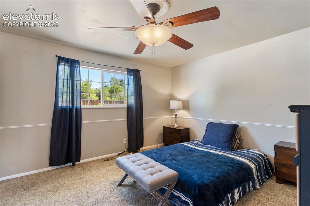 Image 11 of 24: Bedroom with carpet floors and ceiling fan