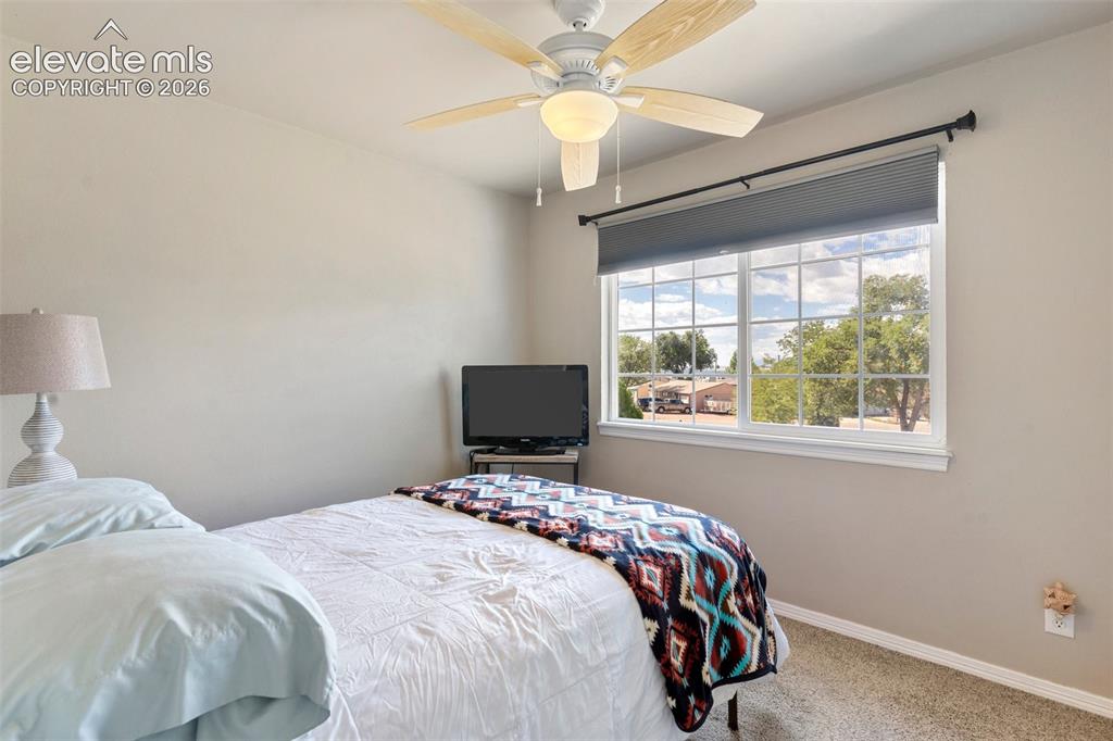 Image 13 of 24: Bedroom with carpet and ceiling fan