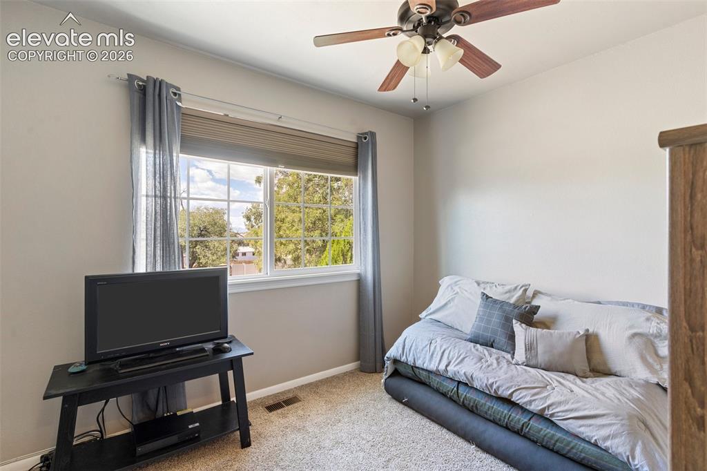 Image 14 of 24: Bedroom featuring ceiling fan and carpet flooring