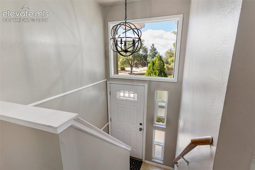 Image 2 of 24: Entrance foyer featuring a notable chandelier