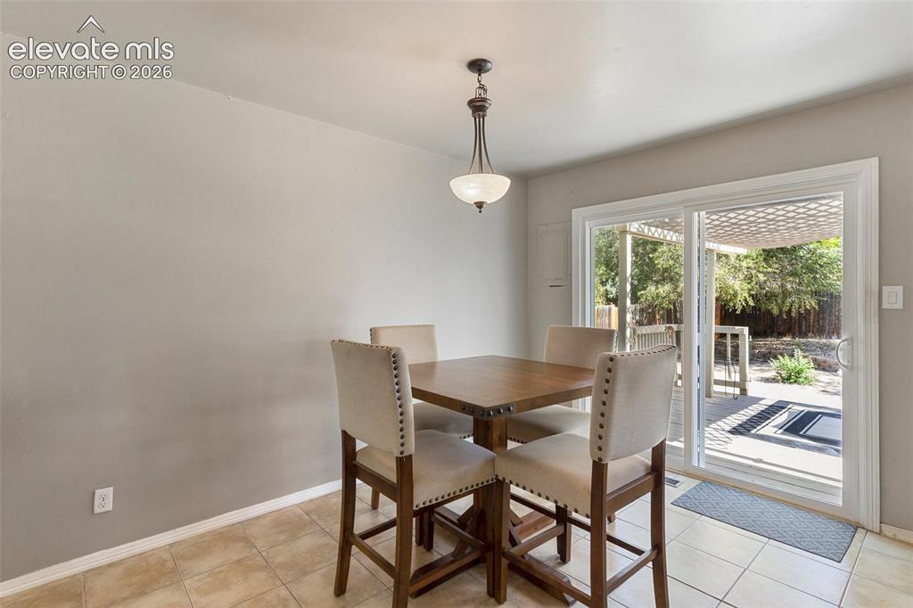 Image 8 of 24: Dining room featuring light tile floors