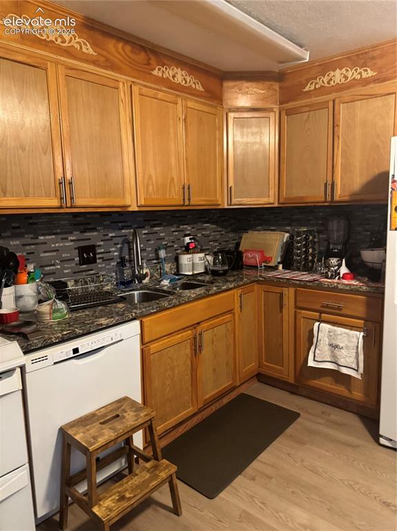 Image 10 of 17: Warm wood cabinetry with brushed metal hardware frames this well-appointed