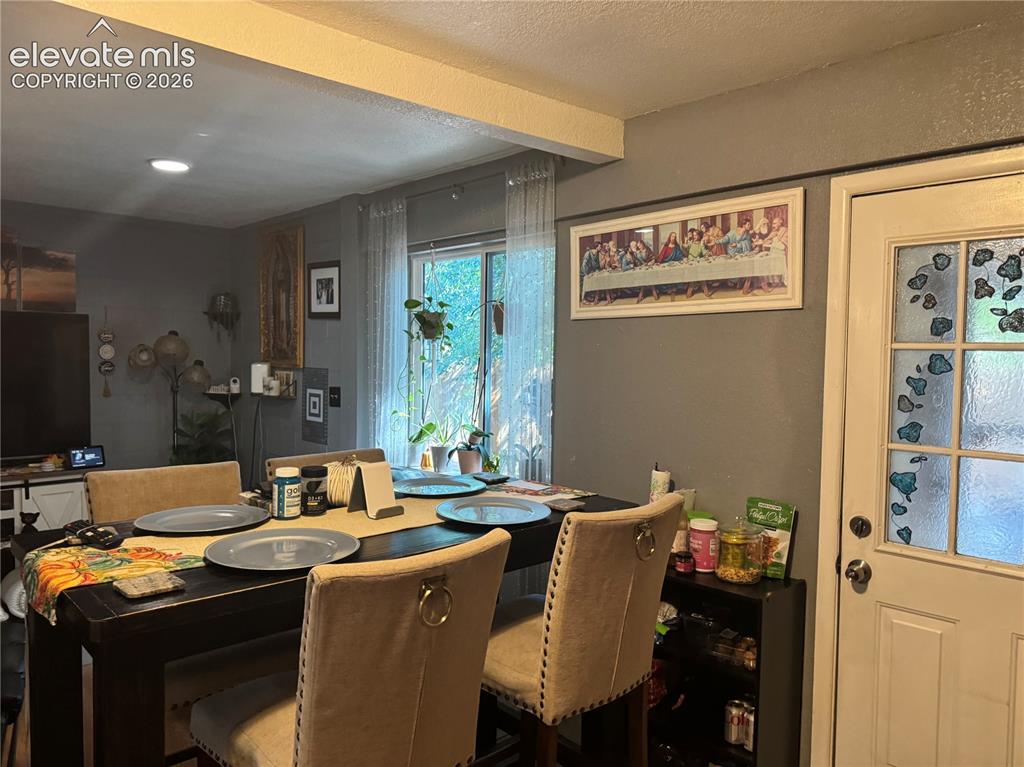 Image 14 of 17: Recessed lighting illuminates the space, featuring a window with sheer cove