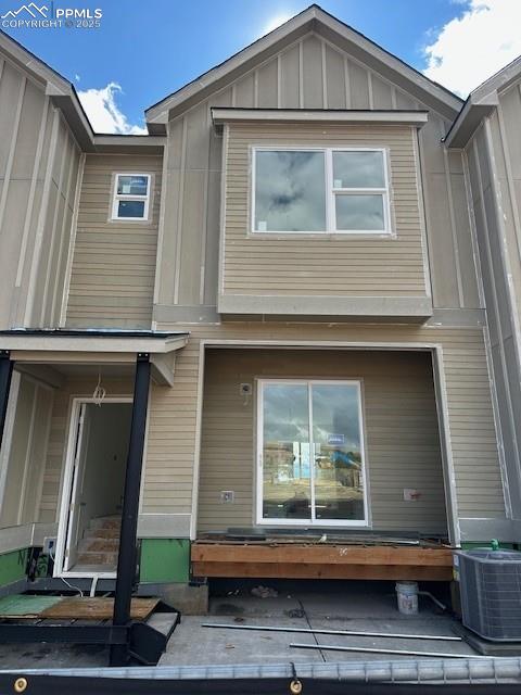 Caption: Rear view of property featuring board and batten siding