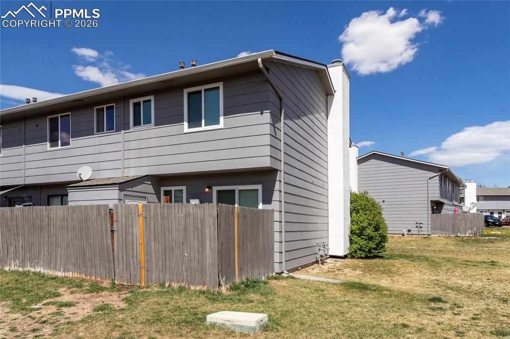 Image 5 of 31: Back Patio and gate to common areas.