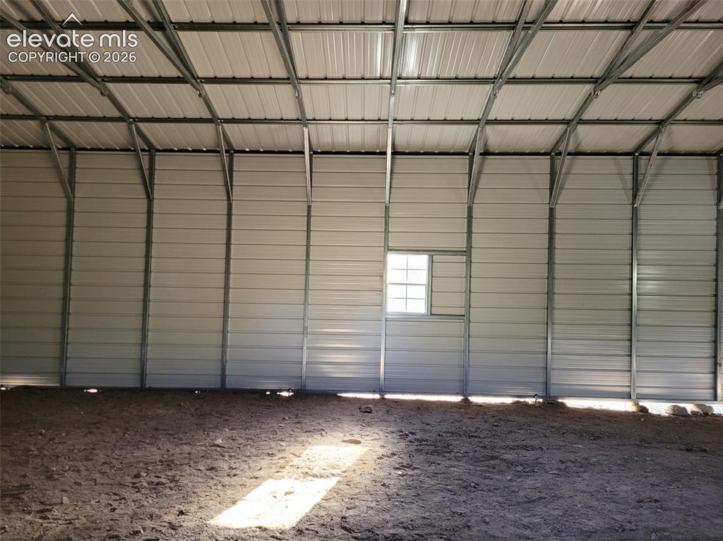 Image 19 of 33: Metal-clad interior walls and ceiling with exposed metal framing