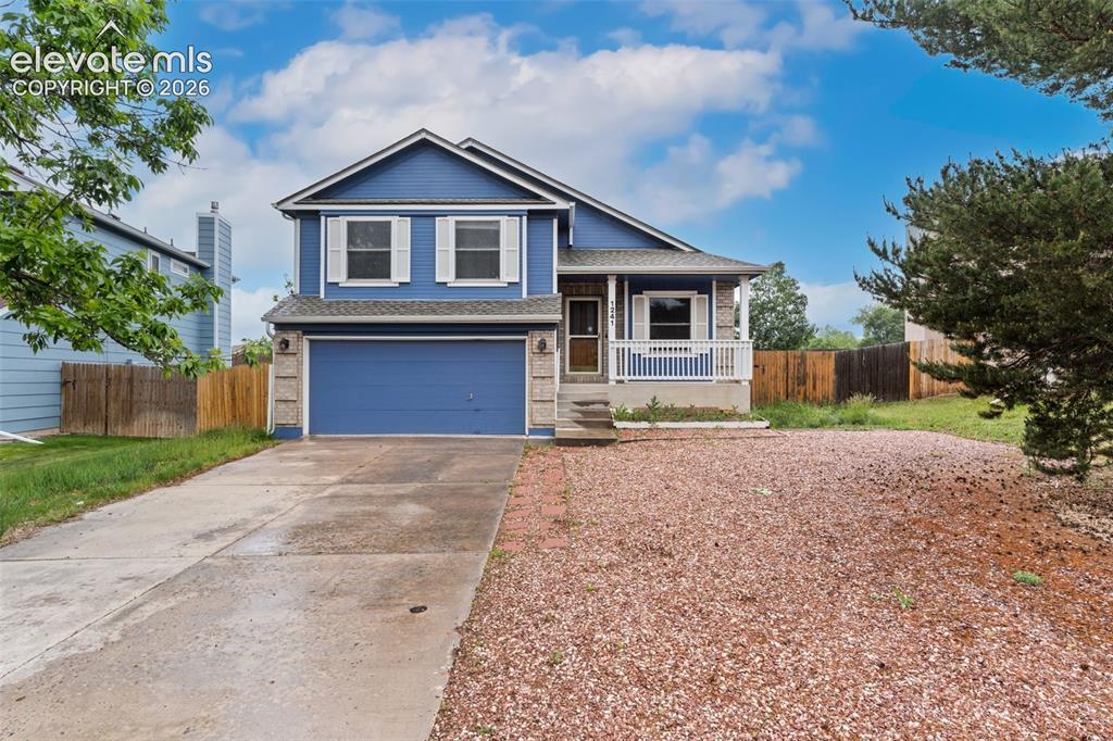 Image 1 of 38: Two-story residence featuring a blue exterior, white window shutters, and a